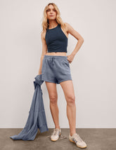blue shorts with patch pockets and a drawstring at the waistband.